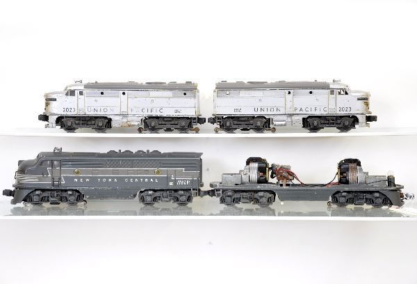 Lionel Diesel Lot: 2353 NYC F3 frame, some light corrosion; 2344 NYC F3 dummy unit showing moderate wear C6; 2023 UP Alco AA diesels, battery damage, showing heavy playwear, C4. The auction containing on the secondary l