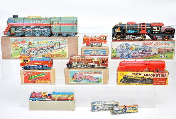 8 Boxed Train Toys: One is a Marx 8" plastic locomotive, others are Japanese tin, largest is 13 1/2". All are like new with original boxes a couple showing wear. C8-9 The auction containing on the secondary lots will beg