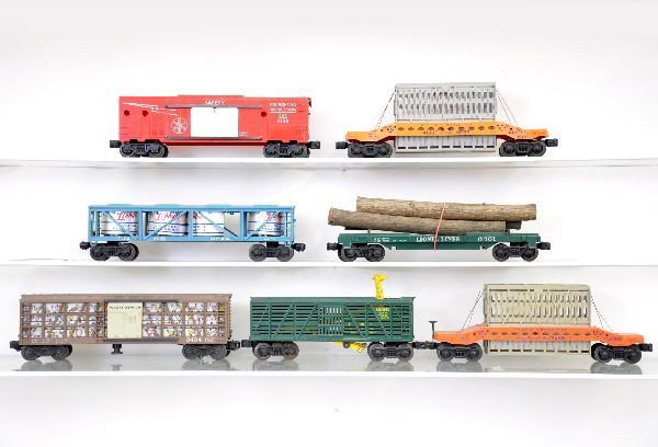 7 Lionel Post-War Freight Cars: 2 #6519 Alis Chalmers cars; 3434 operating poultry car; 6475 Libbys vat car, teal blue; 3376 giraffe car; 6361 timber car; 6530 fire safety boxcar. All have minor issues and minor broken pieces, but s