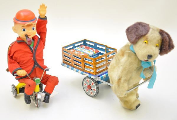 Early Battery Toys: Cycling Daddy, pipe lights, hand waves as he tools around on his tricycle; doggy porter with luggage cart,11" long. The dog walks the cart, then leans forward and speeds up. Both mechanisms are functi
