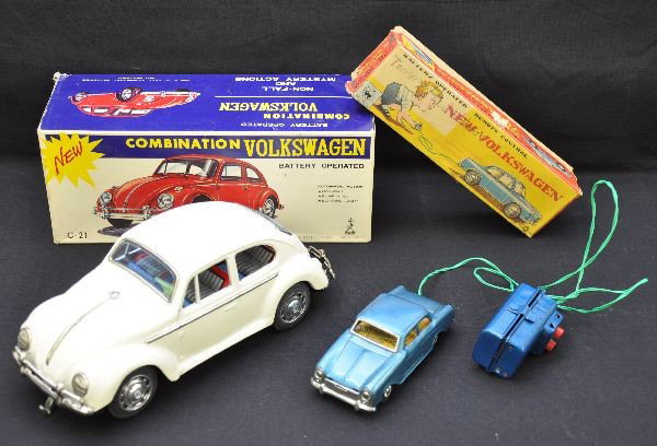 Boxed Japanese Tin VW Battery Toys: White 1960s Beetle by Taiyo Japan, clean & shiny, 9 1/2" long, battery operated, functional (not guaranteed), with mystery action, blinking lights & bump'n go; blue Karmann Ghia by K Japan, 5" long, b