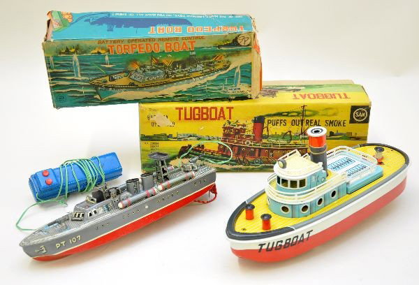 Boxed Japanese Boat Battery Toys: SAN tug boat, 14" long, in-water operation, motor noise & smoking stack; Marx PT 107 Torpedo boat, 12" long, in-water operation forward/reverse, nice details. Both are like new with worn original boxe