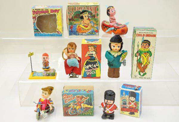 Boxed Japanese Wind-Up Toys: Yone walking guardsman; Suzuki bell cycle; Yone 7" Indian child, some staining on clothes (C7+); Yone fishing boy; Frankonia Sioux-Canoe; dancing ponytail doll. Otherwise, all are like new with their