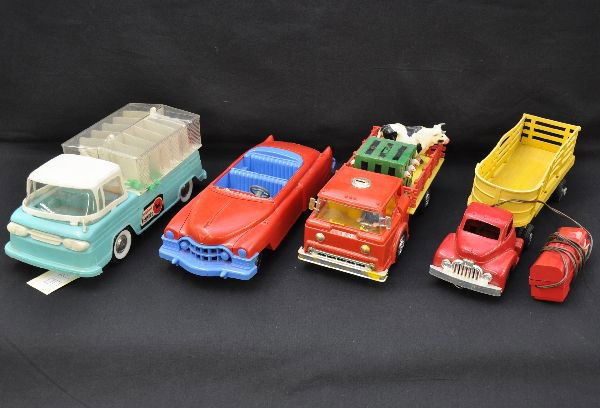 Plastic Toy Vehicles: Andy Gard kennels truck, 11 1/2" long; Saunders cattle truck, tether battery operated, untested; Marx farm truck with one original cow, battery operated, untested but has battery damage; Ideal fix-it