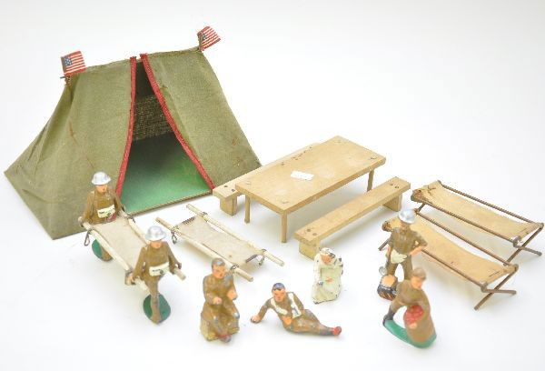 Dimestore Military Lot: Large tent, mess hall table and bench set, two cots, two gurneys, 7 figures including the scarce cook and soldier with apple barrel. All show moderate wear, C6-7