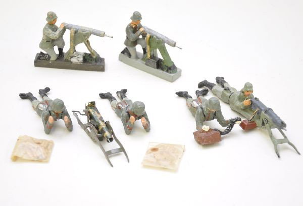 Composition German Soldier Group: 9 pc. Includes Lineol, Elastolin and Schusso figures. Tin machine gun includes two packets of bullets in cellophane. All show light to moderate playwear, C7-7+