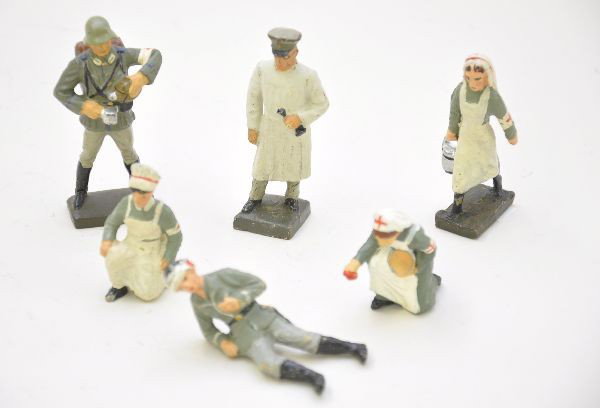 Composition Soldier Group: 3 Lineol figures including surgeon, nurse, figure pouring coffee; Schusso nurse, Elastolin nurse and wounded. All show light to moderate wear, C7-8