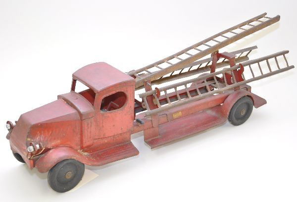 Scarce Turner Ladder Truck: Bulldog Mack design, circa 1920's, painted pressed steel, 25" long, battery operated headlights, paint is faded, original ladders have rust but should compound and wax fairly nicely. Otherwise, shows