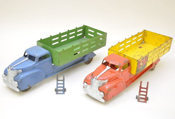 Early Marx Delivery Trucks: Circa late 1930's, painted pressed steel, each 21" long. Stake truck with matching hand truck, showing light to moderate playwear, C7. Coca-Cola truck with hand truck showing moderate to heavy playwea