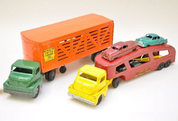 Structo Tractor Trailers: Cattle farms truck, showing light playwear, C7-8; auto loader with 3 original cars and ramp, showing moderate to heavy playwear, C5-6