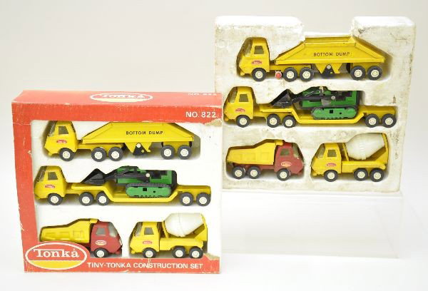 Boxed Tonka Construction Sets: Both are set 822, mini size which includes bottom dump, low loader with dozer, dump truck, cement truck. Both show light to moderate playwear and have original inserts with one original worn box, C7-8