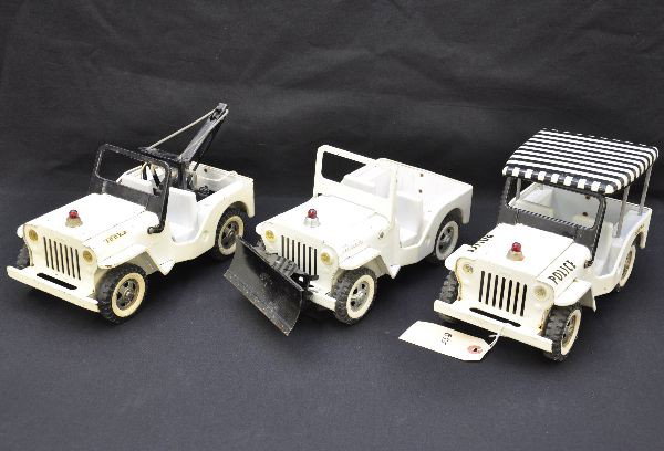Tonka Police Jeeps: Jeep with plow, decals are light, covered jeep and wrecker Jeep, missing hook and line. All show light to moderate playwear, but should clean to C7