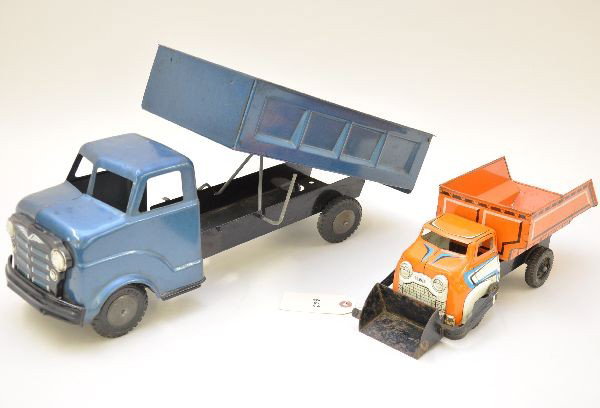 Marx Trucks: 13" sand and gravel truck, some rust spots inside bed and on scoop; 20" dump truck, missing tail gate. Otherwise, both are clean and shiny and show light to moderate playwear, C6-7