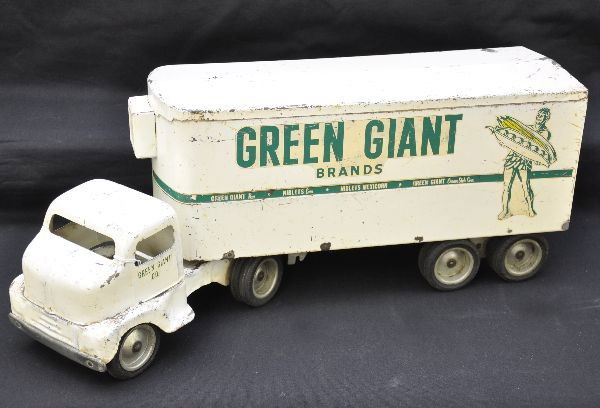 1953 Tonka Green Giant Semi Truck: Painted pressed steel with wooden frame, 21" long, nice light decals, missing one rear door handle and trailer support wheels. Truck shows moderate to heavy playwear but clean, C5