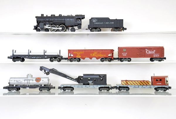 American Flyer Steam Freight Set: S-Gauge. 21160 steam loco & tender; 24540 flat with pipes; 24310 Gulf tank car, cracked; 24216 UP hopper; 24003 SF boxcar; 24543 wrecker; 24546 boom tender. Otherwise, trains show light to moderate pl