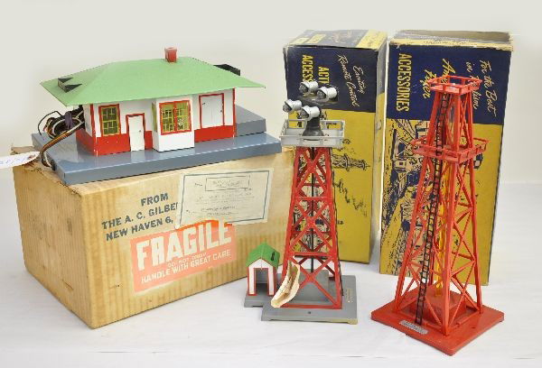 Boxed American Flyer 755, 773 & 774: 755 talking station, missing speaker & controller; 773 floodlight tower; 774 oil derrick, all red version. All have nice original boxes (755 actually stamped 750 trestle bridge??) and show light playw