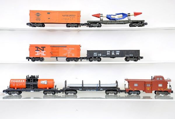 American Flyer 5 Digit Freight Cars: S-Gauge. 24403 IC reefer; 24537 NH flat with pipes; 24324 hooker tank car; 24103 N&W gondola; 25082 NH Hay-Jector with 3 bales; 24533 rocket transport, 1 broken rocket, (C6); 24619 bay window caboose.