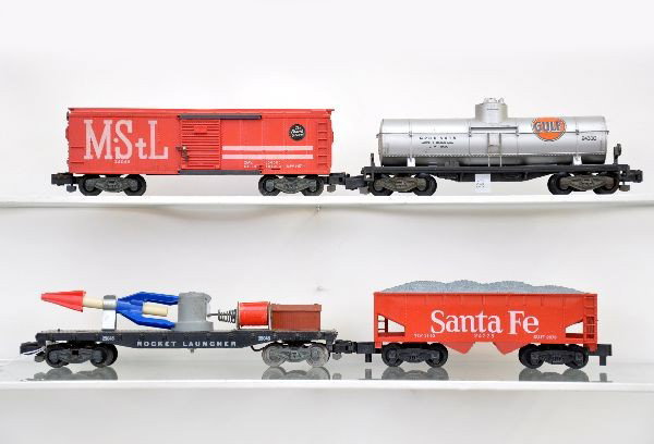 American Flyer Freight Cars: S-Gauge. 24552 SF hopper with nice ob; 25045 rocket launcher; 24310 Gulf tank car; 24048 M&StL boxcar. All show light to moderate wear and should clean to C7-7+
