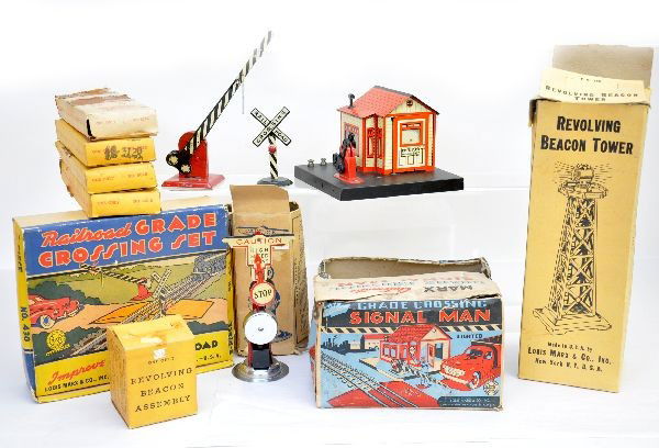 Boxed Marx Accessories: Grade crossing signal man, 430 grade crossing set with insert, 446 beacon tower, 417 bell ringing signal, revolving beacon assembly, 2 #601B straight tracks plus one extra empty box, 602B curve track