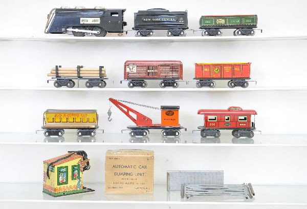 Pre-War Marx Steam Freight Set: Commodore Vanderbilt loco, NYC wedge tender, gondola, flat with logs, open stock car with partial corral, tipple car with boxed 1614 dumping unit, wrecker, caboose. Rolling stock are scarce 4 wheel tr