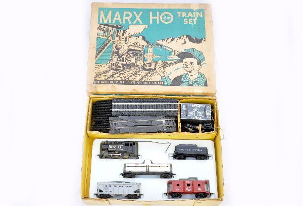 Boxed Marx HO Set 17940: NYC steam switcher and tender; RF tank car; cement car; NYC bay window caboose, 35 pc. paper village set with envelope, peripherals, track & transformer, shows light playwear, C8