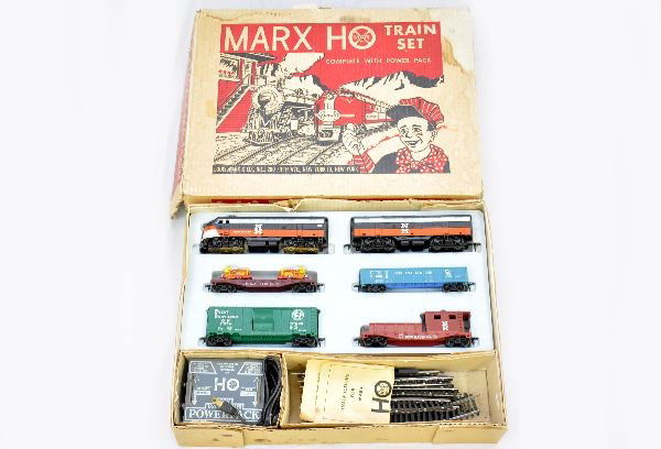 Boxed Marx HO Set 64888: NH F3 AB diesels, b-unit missing 1 step; C&O gondola; IHCX flat with dozers, no treads; GN boxcar; NH work caboose, track, transformer, set box with inserts. Set shows light to moderate playwear other