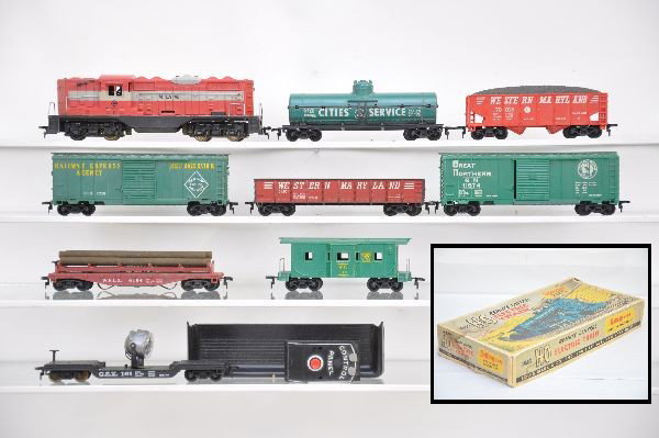 Marx HO Diesel Freight Set: Monon GP7 Diesel; CS tank; WM hopper; REA boxcar; WM gondola; log dump car with bin & controller; GEX searchlight; WP bay window caboose, no stack. All are clean & show light playwear, C7+-8
