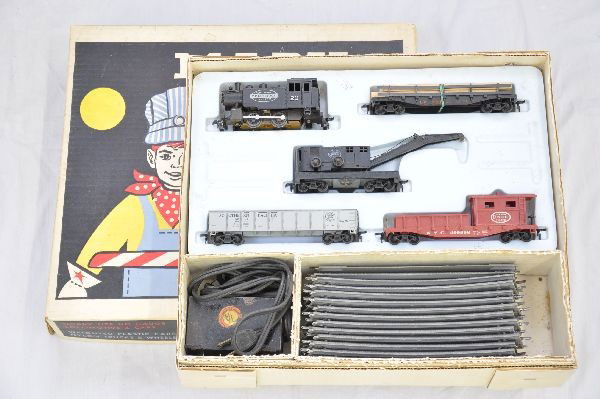 Boxed Marx HO Allstate Set 17465: Cute work train. NYC Dockside switcher, LV railed flat with lumber, NYC wrecker, no hook, SP gondola, NYC work caboose, track, transformer, set box with inserts. Trains show light playwear, C7+