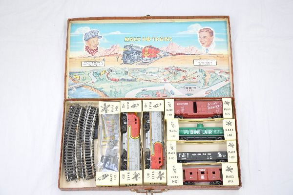 Boxed Marx HO Suitcase Set: SF F3 AA Diesels; UP boxcar; Sinclair tank; C&O gondola; SF bay window caboose, no stack; accessory set, track, individual box and set box with some rust on latch & handle. Trains show very light play