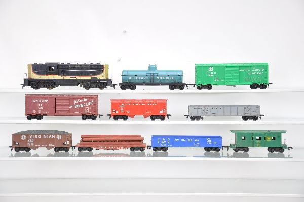 Diesel Freight Set: NP GP-7 Diesel, cab has chip near clip on side; Allstate tank; SF boxcar; Virginian hopper; UP boxcar; cement car; SP gondola; WFLX log dump; C&O gondola; WP bay window caboose. Otherwise, shows light