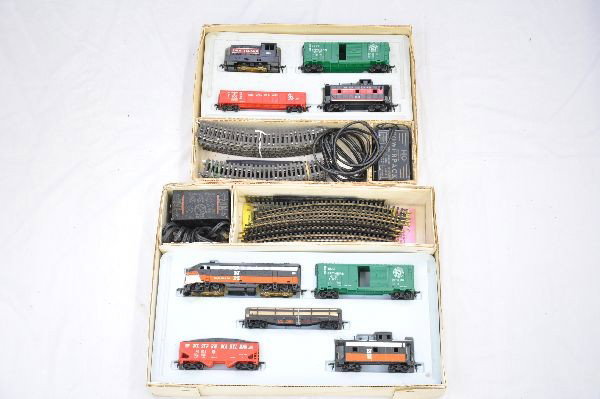 Boxed Marx HO Sets 16470 & 164545: 16470- RI diesel; NYC boxcar; C&O gondola, 1 cracked step; RI Caboose, track & transformer; 16545 - NH F3 diesel; GN boxcar; LV railed flat with lumber; WM hopper; NH caboose, track & transformer. Bot