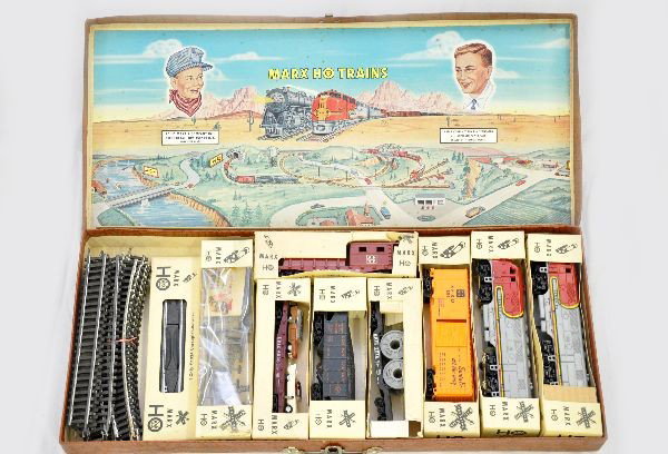 Boxed Marx HO Diesel Suitcase Set: SF F3 AA diesels; SF boxcar; NYC boxcar; LV hopper; Erie flat with autos; Erie reel flat; SF work caboose, accessory set, track, and suitcase set box. All have original boxes and show light playwear, 