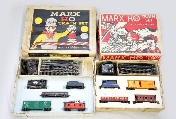 Boxed Marx HO Sets 17575 & 16850: 17575 contains NYC steam switcher & tender; LV railed flat with lumber, hold-down clips rusty; GN boxcar; NYC caboose, track & transformer; 16850 includes blue diesel; SF boxcar; WM gondola; NYC bay w