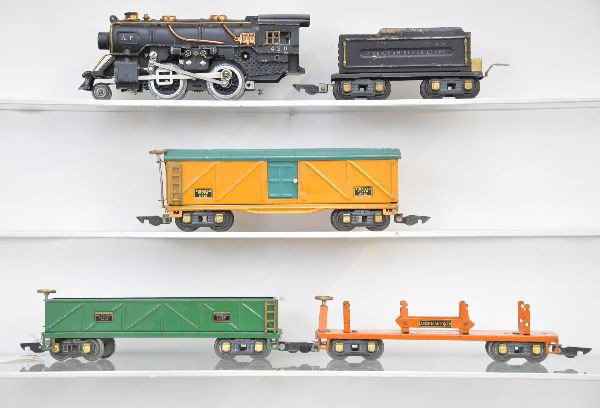 American Flyer Freight Set: 420 steam loco, re-wheeled, nice cab lettering; AFL tender; 3207 sand car; 3216 machine car (both have knuckle trucks); 229 boxcar. All show moderate playwear, otherwise C6