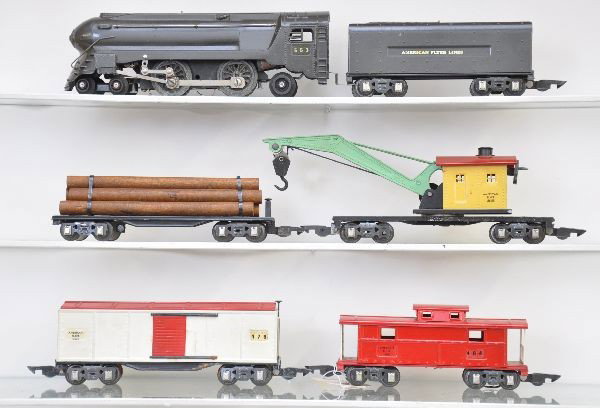 American Flyer Freight Set: O-Gauge. 553 torpedo locomotive, some fatigue to drivers; matching AFL tender, gun metal; flat with logs; 514 wrecker, some flaking around crank; 478 boxcar; 484L illuminated caboose. Otherwise, set i