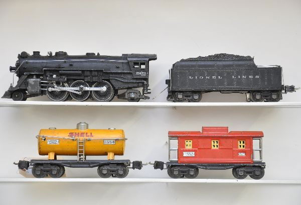 Lionel Train Set: 225E locomotive, replaced boiler ring and missing jewels, very minor bend to rear cab corner; 2235W die cast tender; 2654 Shell tank car; 2657 caboose. All show moderate playwear, should otherwise cle