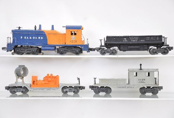 Lionel Diesel Freight Set: 6250 Seaboard NW-2 diesel, rubber stamped version, cab decals 100%; 3620 searchlight car; 3469 coal dump car, minor glue residue near brake wheel; 6419 work caboose, corner chips on tool boxes. Otherw
