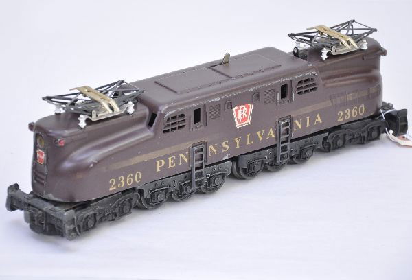 Lionel 2360 Pennsylvania GG1: Tuscan single stripe with uneven ventilators, stripe is 70% one side, 40% the other, side decals the same. Otherwise, engine shows moderate playwear, C6