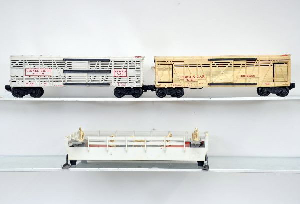 Lionel Circus Car Lot: 3366 operating circus car with corral. Car is unusual as the entire car has yellowed evenly. Includes 6 original horses; 3376 circus car with nice trim paint. Both need a cleaning, but should clean to