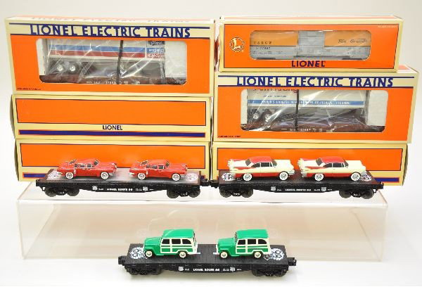 Boxed Lionel Flat Cars: Includes 17536 with Route 66 autos in cream/red variation, 36000 Route 66 flatcar with sedans, 36001 flatcar with wagons, 17887 LCCA 1991convention car (Armstrong), 17888 LCCA 1991 convention car (For