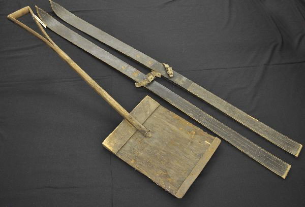 Early Wooden Skis & Snow Shovel: Lurril Vintage Wooden Skis, 68" long with worn leather straps, shows signs of wear and use with original patina. 48" show shovel, all wood with metal edge, shows heavy use.