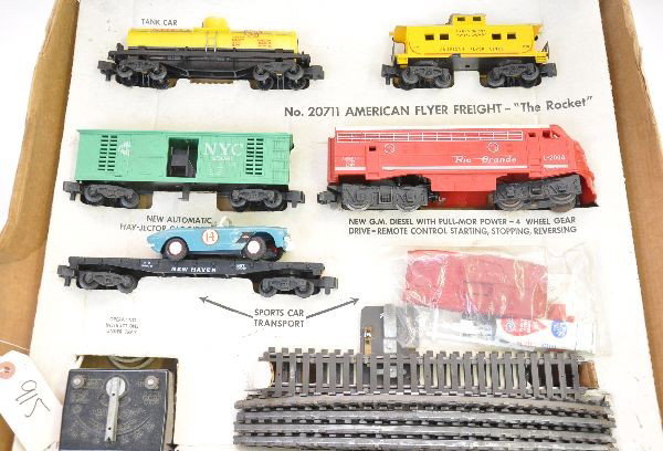 Boxed American Flyer Set 20711: S-Gauge. Includes L2004 Rio Grande F9 diesel; 24578 flat with Corvette kit, blue kit is assembled but includes complete red kit unassembled with glue; 25081 NYC hay jector, no load; 24328 Shell tank c