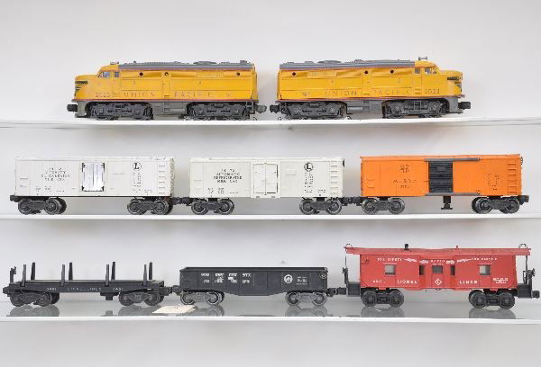 Lionel Double Diesel Freight Set: 2023 UP Alco AA diesels, one shell cracked (C3) ; 3462 milk car, cans inside, early brass mechanism, no platform; 2452 gondola with ob; 3461 log dump car, no load; 3464 Santa Fe operating boxcar; 3472