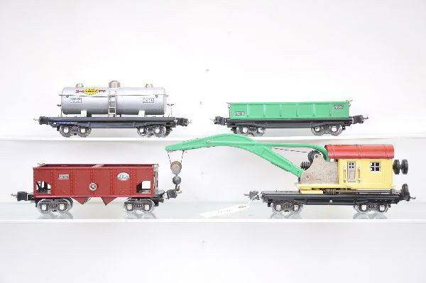 Restored Lionel Freight Cars: Pre-War. Professional, high quality restoration. 2810 wrecker, 2816 hopper, 2812 gondola with 9 small barrels from 3652, 2815 Sunoco tank car. All nicely done.