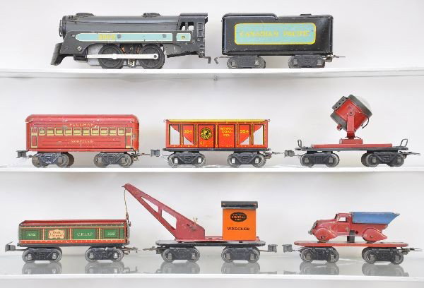 Pre-War Marx Freight Set: 3000 loco, CP tender, gondola, wrecker, Montclair Pullman, hopper, searchlight (missing pick-up) and red flat car with dump truck. All have automatic couplers and show moderate playwear, C6-7
