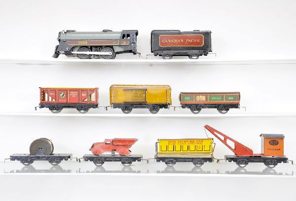 Pre-War Marx Freight Set: 3000 loco, pick-up incomplete; CP tender; flat with cable reel; hopper; wrecker; flat with all red dump truck; gondola; B&O boxcar and tipple car. All show moderate to heavy playwear, C5-6