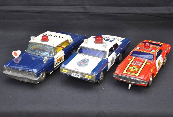 Emergency Vehicle Battery Toy Lot: All litho thin, largest is 12" long. Includes Olds Toronado Fire Chief Car, Taiwan; Cragstan 66 Fairlaine Police Car, missing one top siren, chrome worn and small dent in front bumper; Highway Patrol 