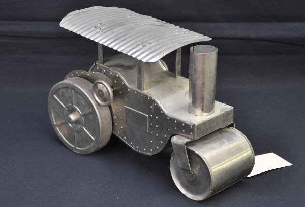 Early Lindstrom Road Roller: 11 1/2" chrome plated pressed steel and tin. Mechanism winds but no action at time of test. Fairly clean, showing light to moderate playwear, C7