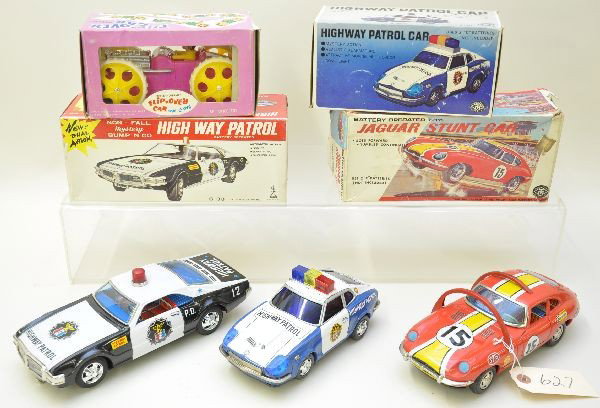 Boxed Toy Vehicle Lot: All battery operated vehicles. Amico flip over car with clown, plastic, Hong Kong; small Modern Toy Datsun highway patrol; Taiyo Oldsmobile highway patrol. All three have clean battery boxes and are l