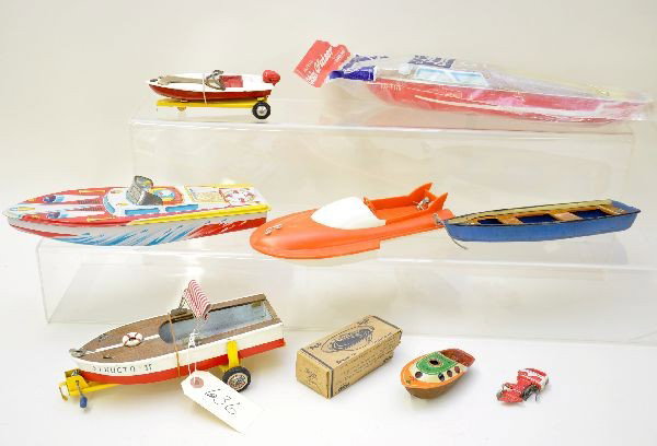 Toy Boat Lot: Largest piece is a 15" Ohio Art cabin cruiser, sealed in bag, (C10); smallest is a boxed CK Japan Pop Pop steam boat with rough ob; Structo II is a wooden Japanese boat on metal trailer with metal mot
